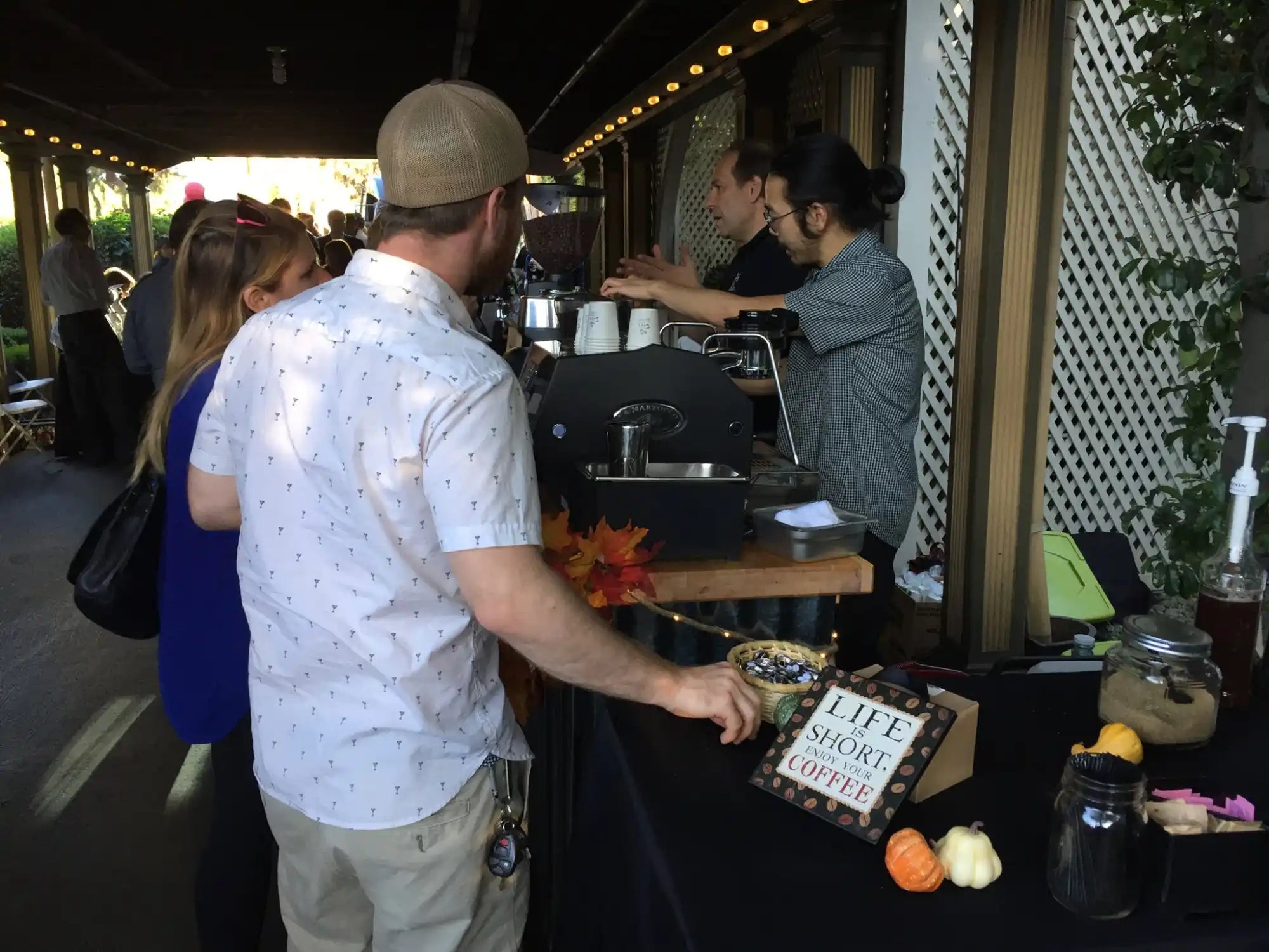 People gathered at an outdoor bar or serving station.